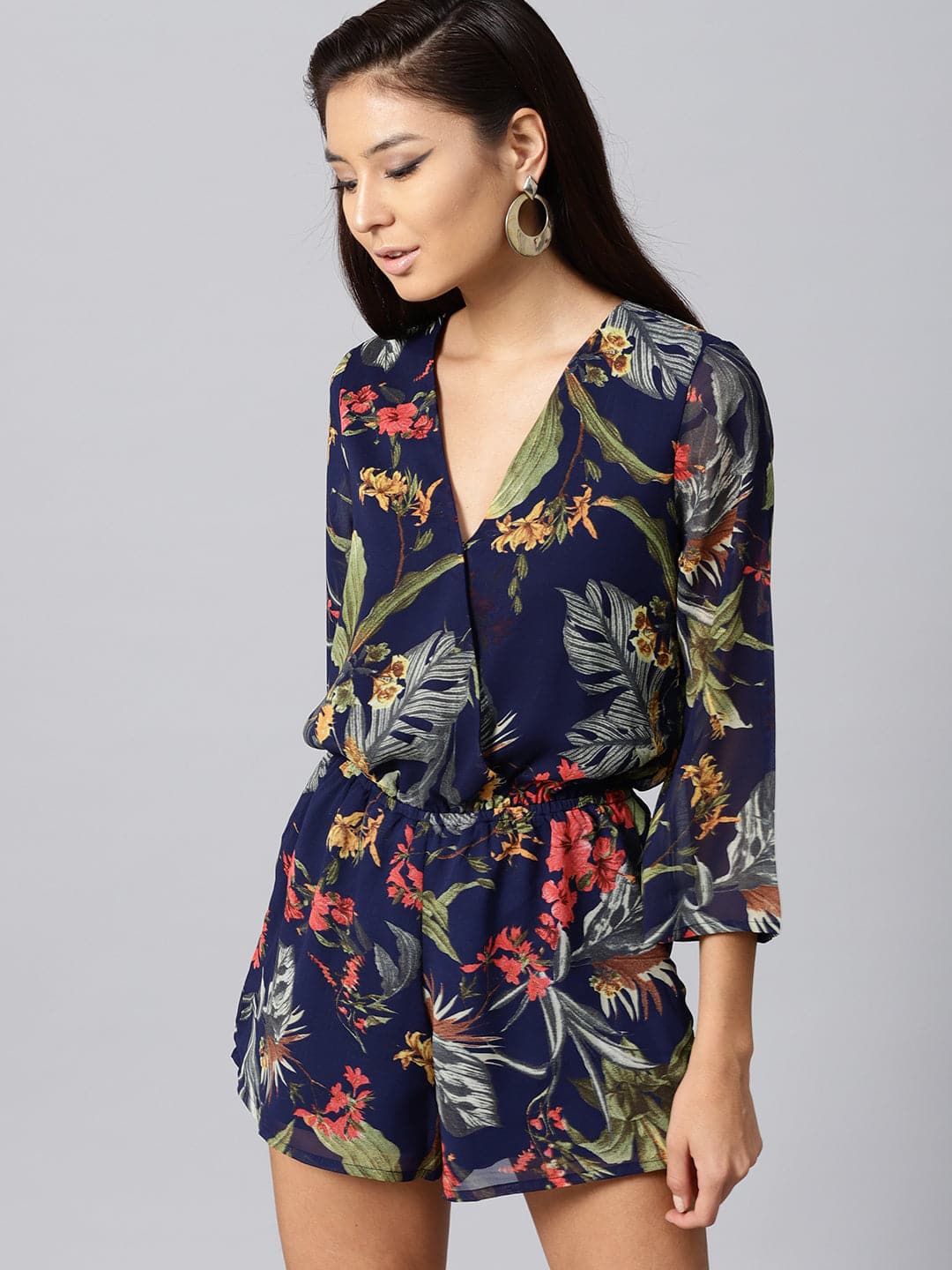 Women's Navy Tropical Wrap Romper in Georgette by Sassafras for wholesale, bulk, supplier, manufacturer and wholesaler buyers from Trendphoria